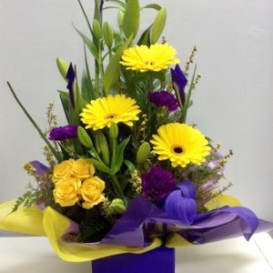 A Large Bright Yellow and Purple Mixed Box Arrangement